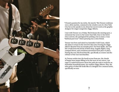 Spread with a dim photo of guitar headstocks on stage and the opening page of the interview article